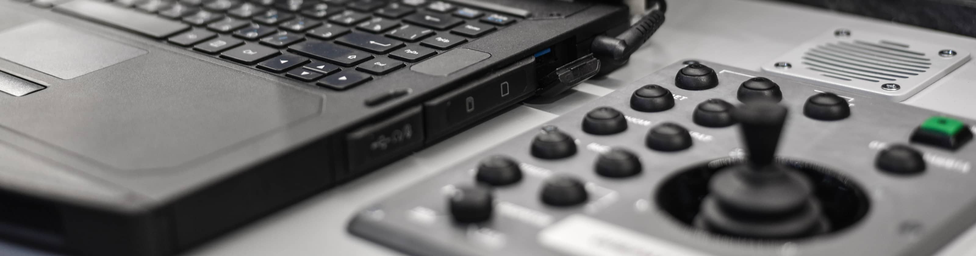 Close up of black drone monitoring equipment, including a keyboard and joystick
