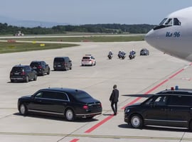 a vip convoy going from airplane with cars
