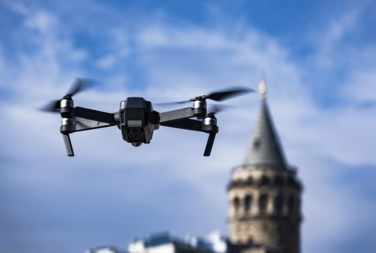Close up of an airborne drone flying towards a prison guard tower