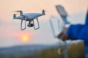 Person flying a drone with a controller. Radio frequency analysers can intercept signals between the to detect drone activity